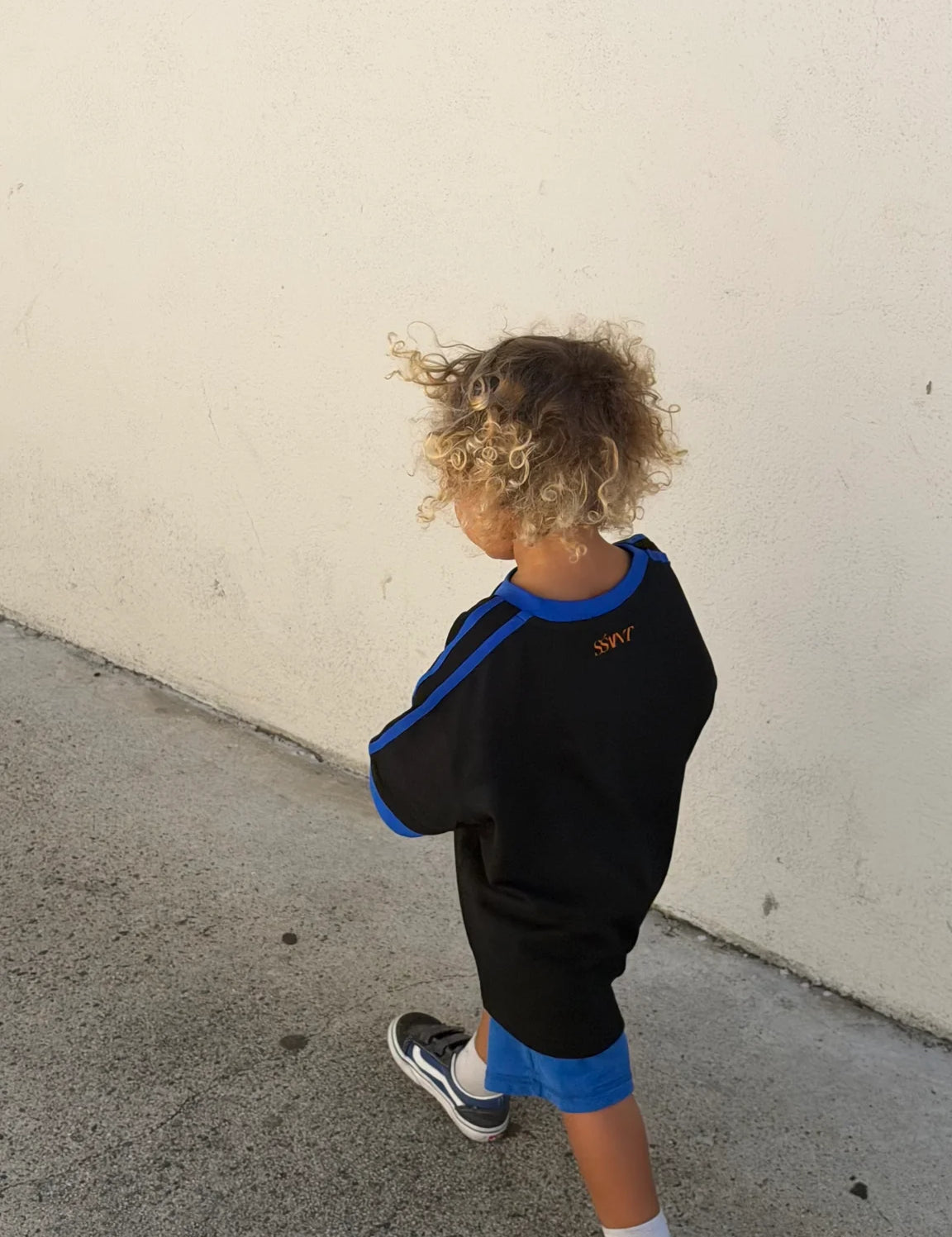 Back view of Kids Twenty Two Tee, blue stripe sleeve detail, relaxed fit, Wild West Sisters