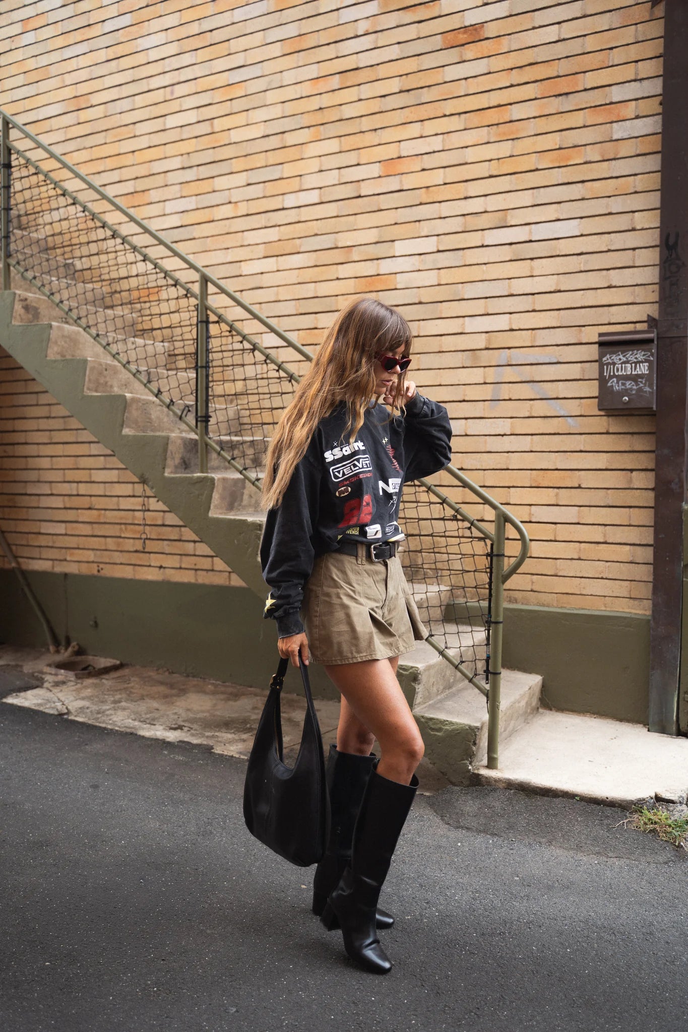 Model wearing SSAINT Signature Moto Long Sleeve in Black Acid Wash oversized fit