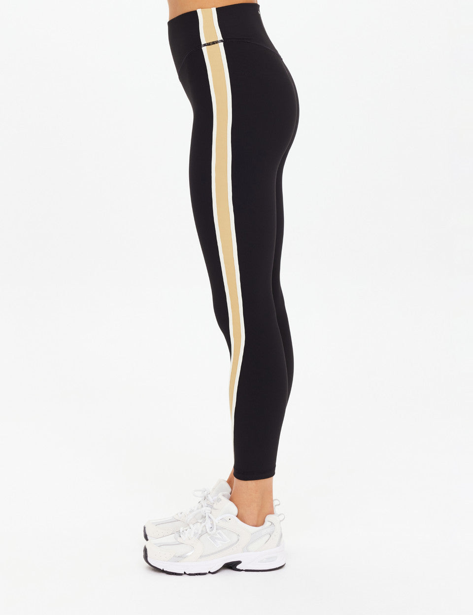 Side view of The Upside Arcadia High Midi Pant showing cream contrast binds and midi length.”