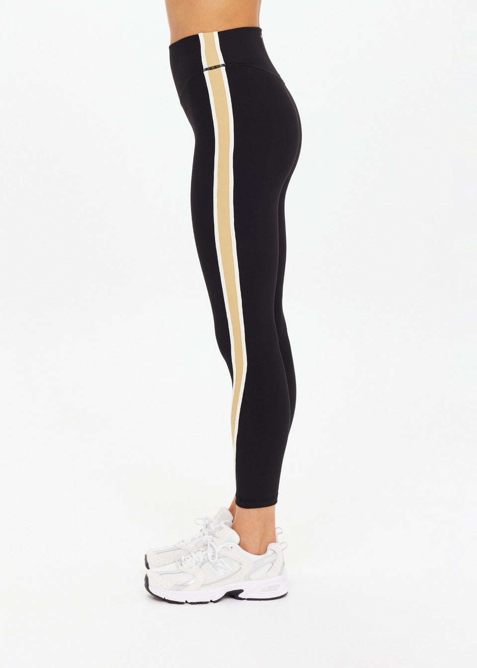Side view of The Upside Arcadia High Midi Pant showing cream contrast binds and midi length.”