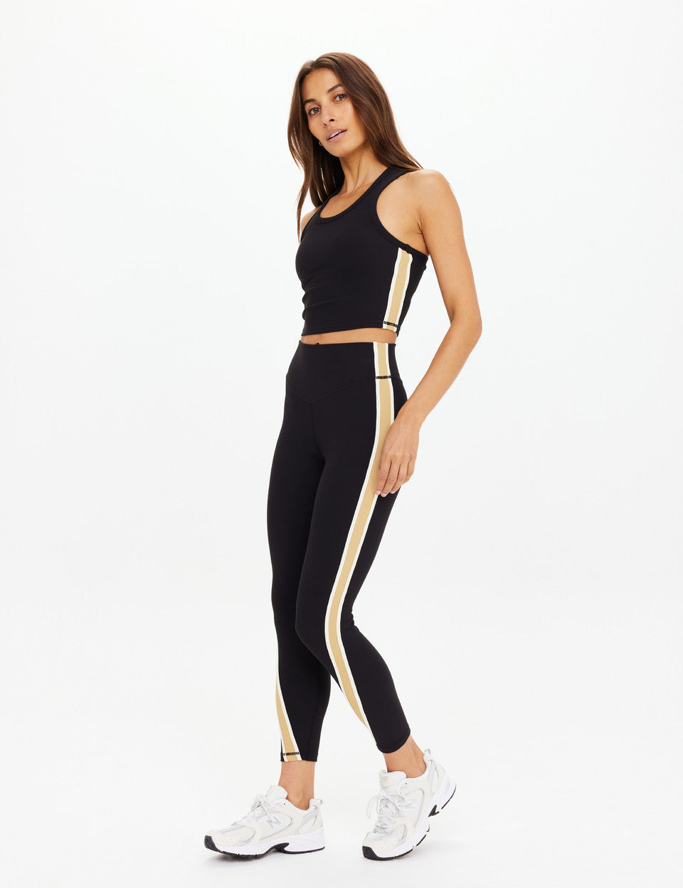 The Upside Arcadia matching set – Sophie Crop Top and 25in High Midi Pants in black with contrast tan side panels and cream binds.”