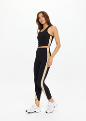 The Upside Arcadia matching set – Sophie Crop Top and 25in High Midi Pants in black with contrast tan side panels and cream binds.”