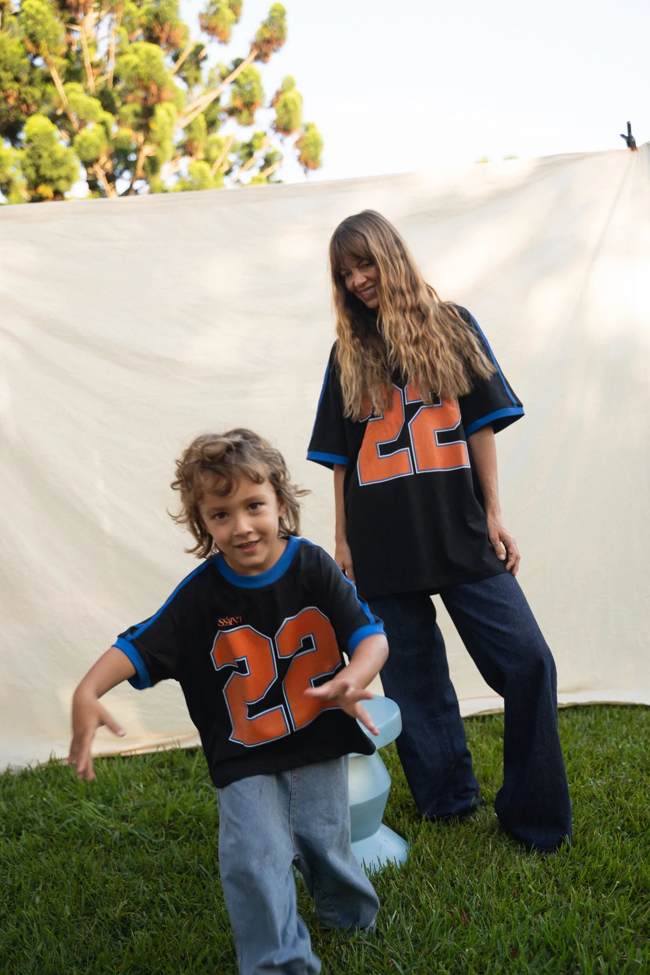 Kids Twenty Two Tee in black with bold orange 22 graphic, Wild West Sisters