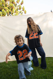 Kids Twenty Two Tee in black with bold orange 22 graphic, Wild West Sisters