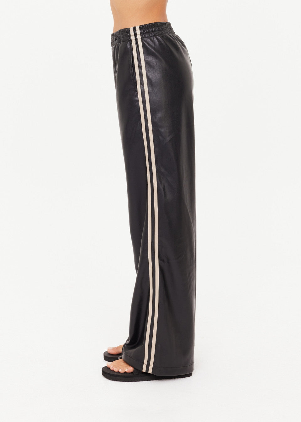 Black leather pants with white stripes on a white background