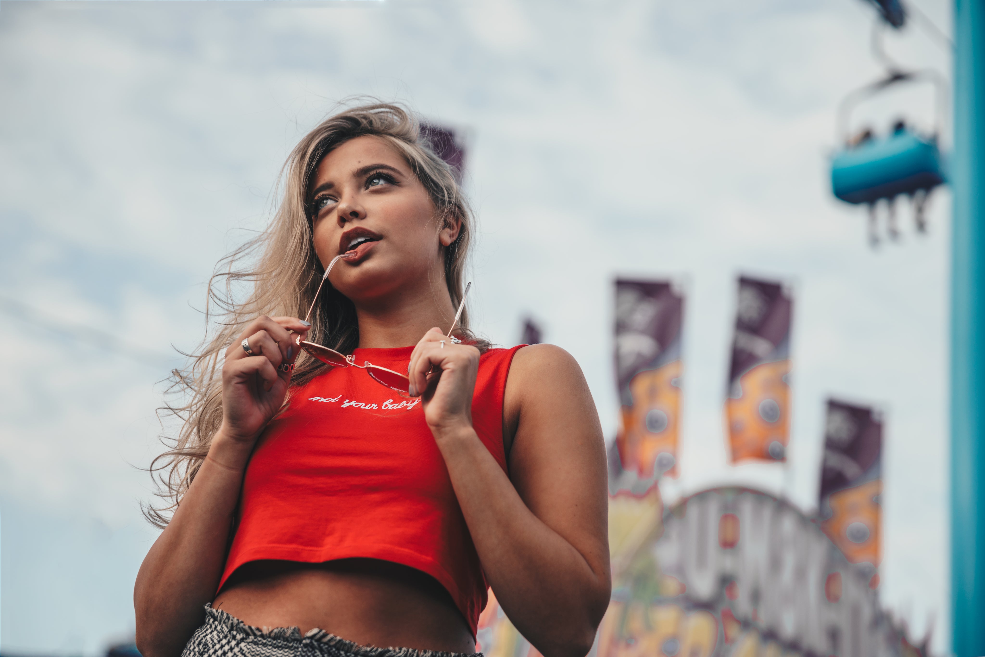 young-woman-holding-sunglasses_8bb3aa82-ebb6-4522-ae2a-45945066636b.jpg